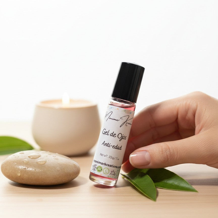 monimarkreations AgeLuxe Anti-Aging Eye Gel in a rollerball bottle with a black cap, on a fluffy white background.